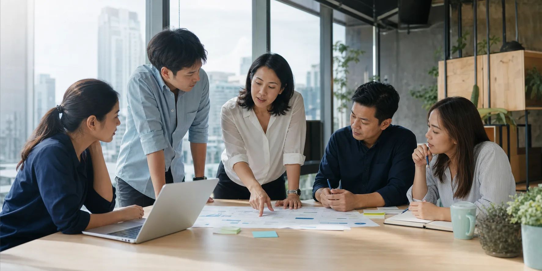 A Thai business team planning work together in a Bangkok office